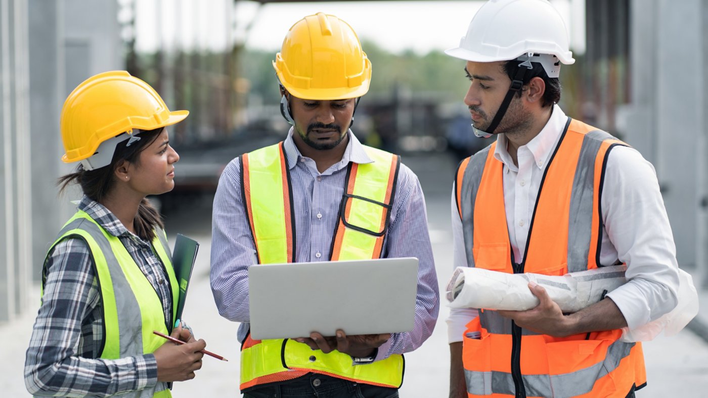 three-construction-workers-on-laptop