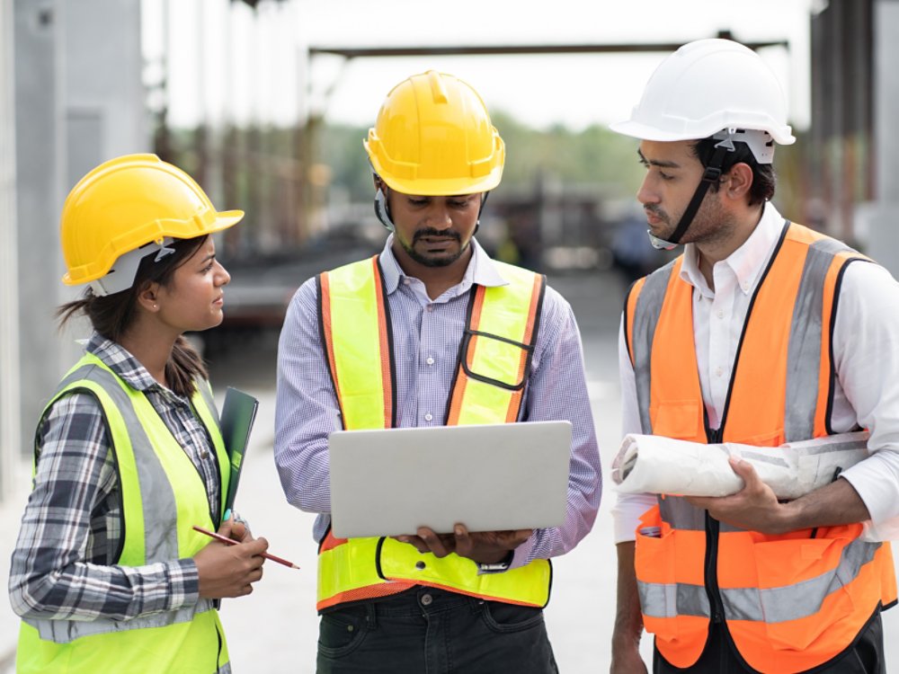three-construction-workers-on-laptop