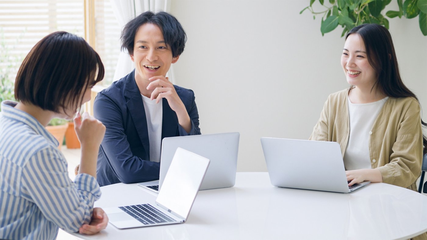 Three people with laptops