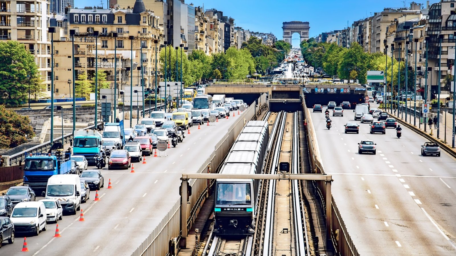 Paris traffic with roadworks viewed from La Defense toward Arc De Triomphe, car vehicles, metro train rush hour
