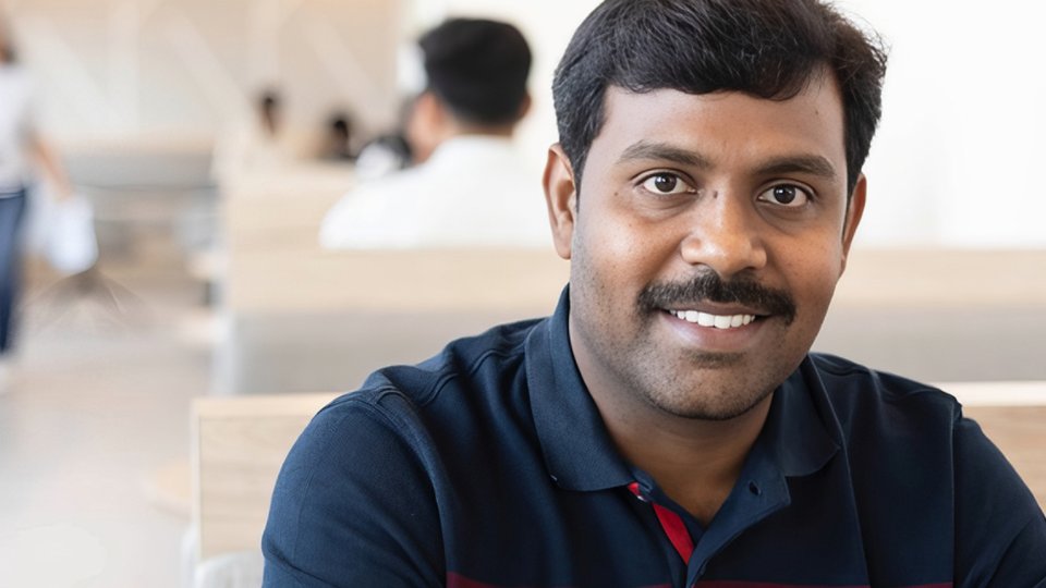 Male employee from India working on his laptop