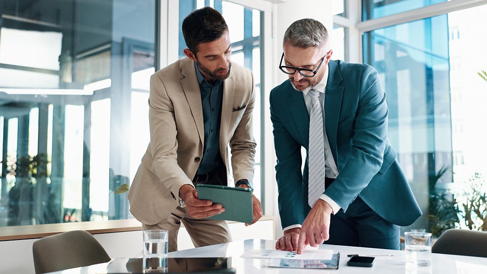 Business, people and meeting on tablet at office of planning, financial documents and company growth. Men, collaboration and paperwork with profit graph, investment report and feedback of opportunity.
