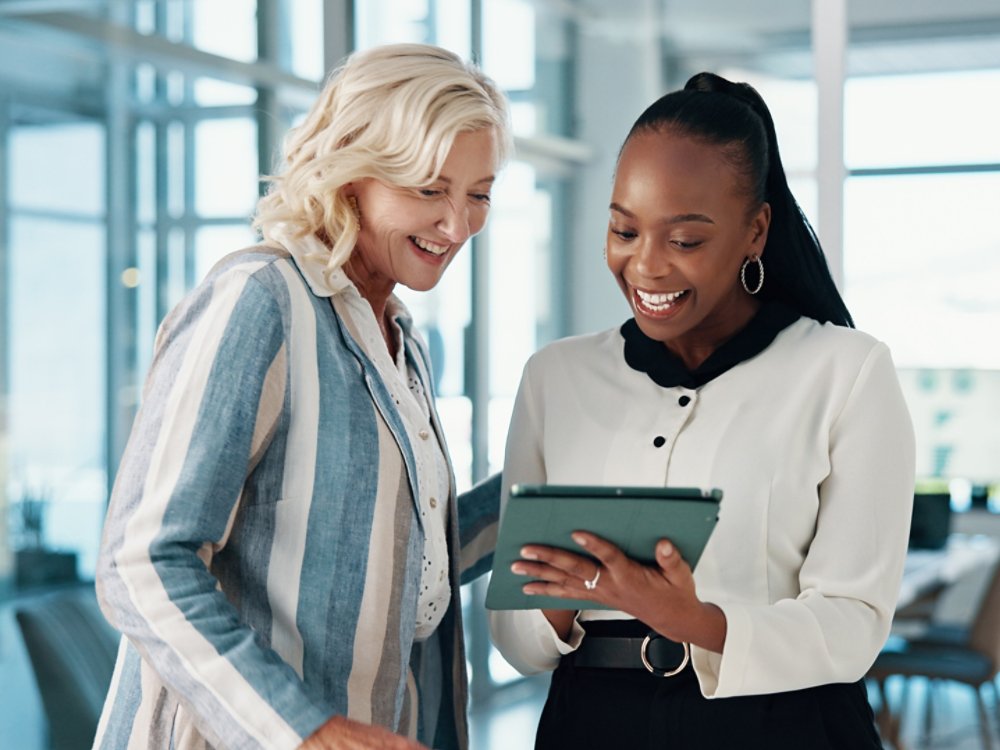 Tablet, cooperation and business people in office, conversation and email with positive feedback. Happy employees, partner and consultants with tech, teamwork and digital app for profit increase.