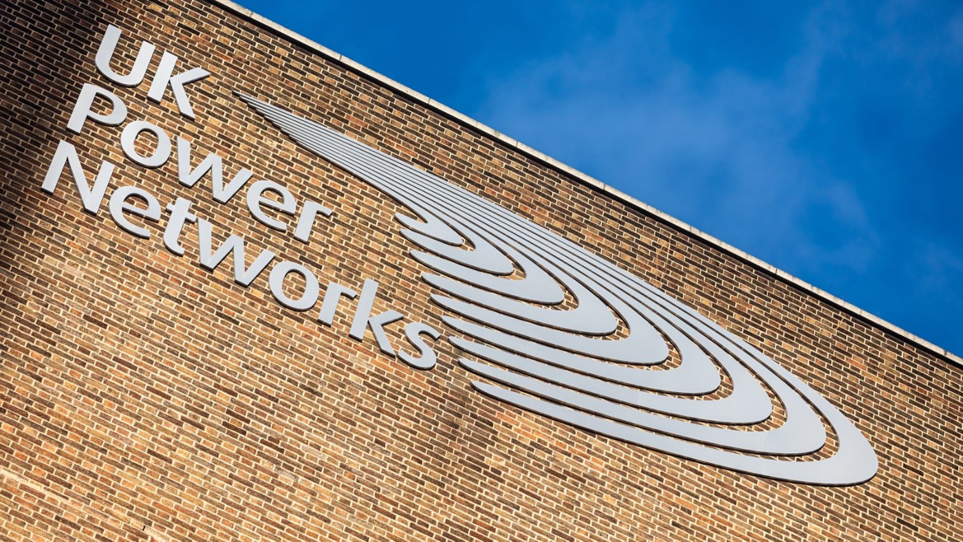 UK Power Network's logo on a brick wall.