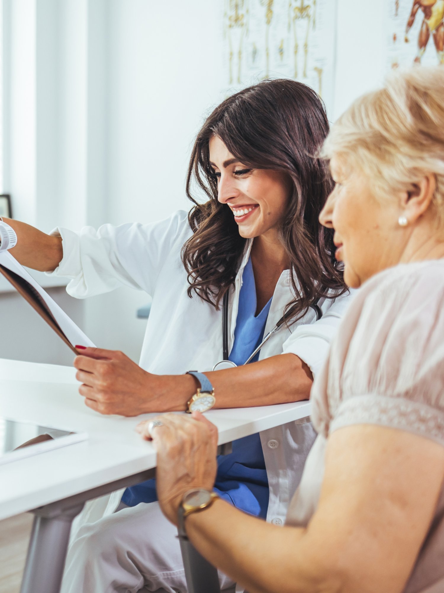 Doctor working in the office and listening to the patient, she is explaining her symptoms, healtcare and assistance concept. Woman patient visiting female doctor at clinic office.
