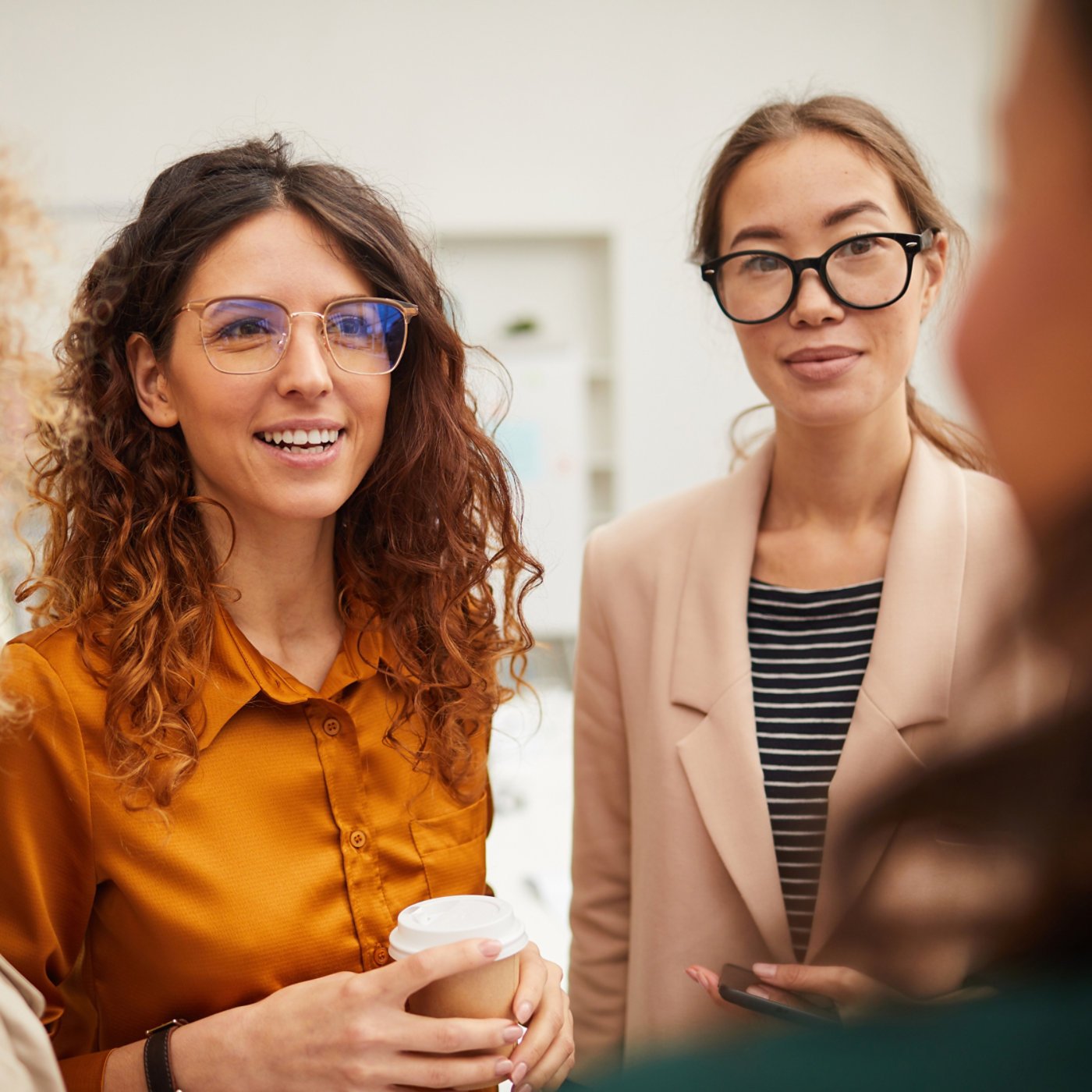 Two businesswomen wearing glasses