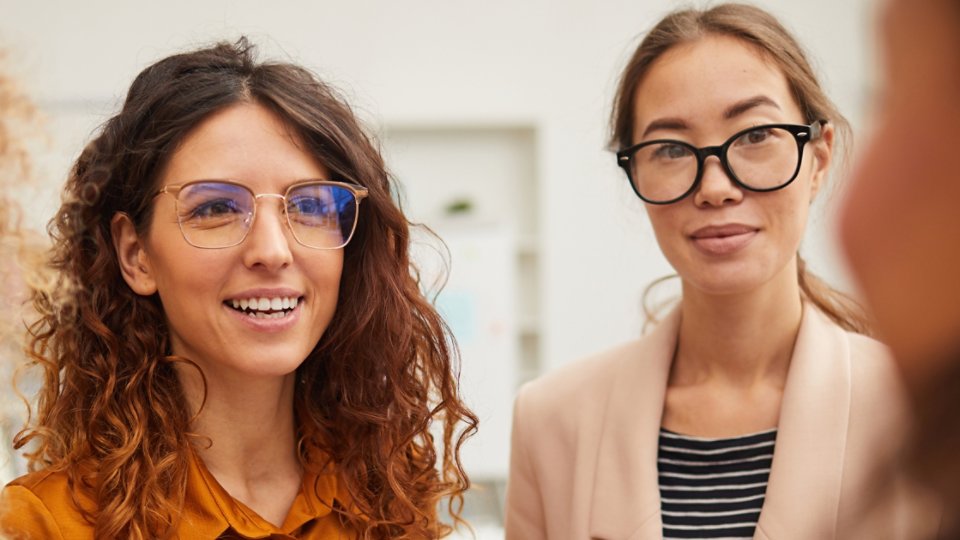 Two businesswomen wearing glasses