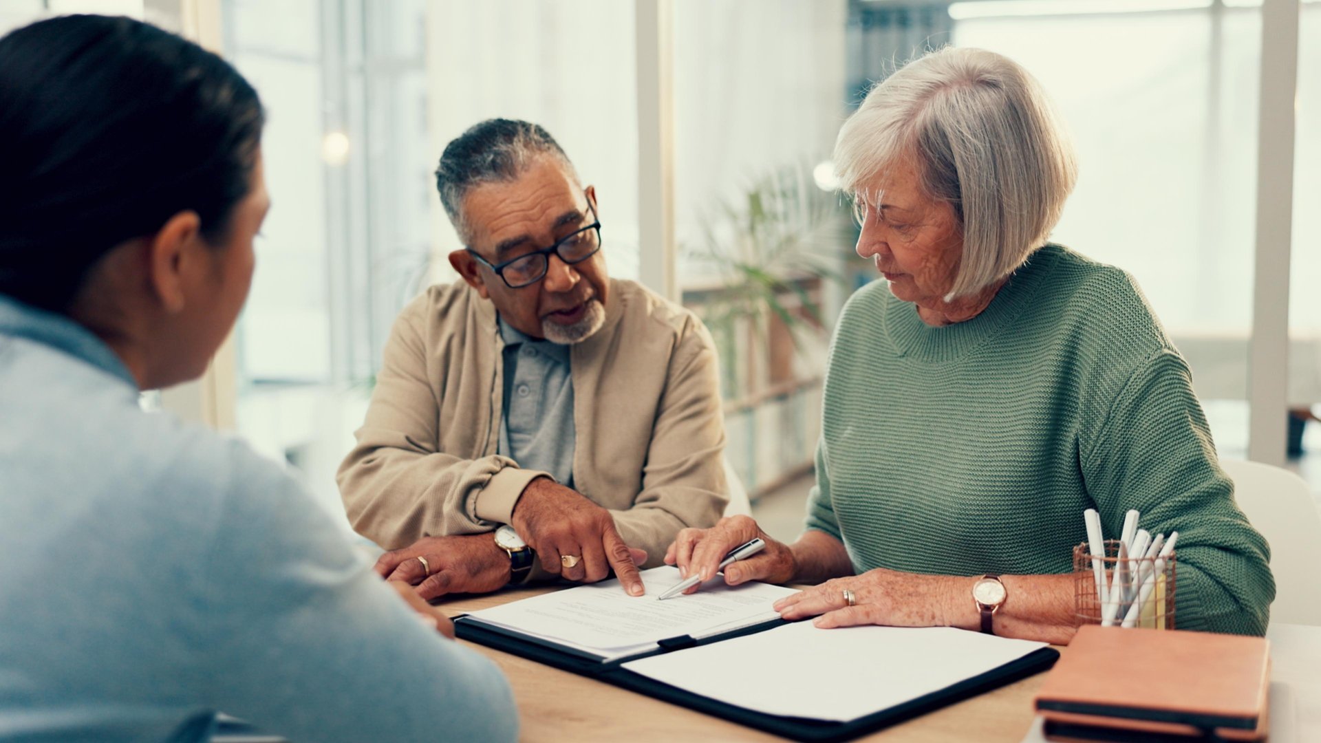 Office, lawyer or old couple with will, contract or document for retirement funding or compliance. Plan, advisor or married elderly clients with legal form or title deed agreement with life insurance.