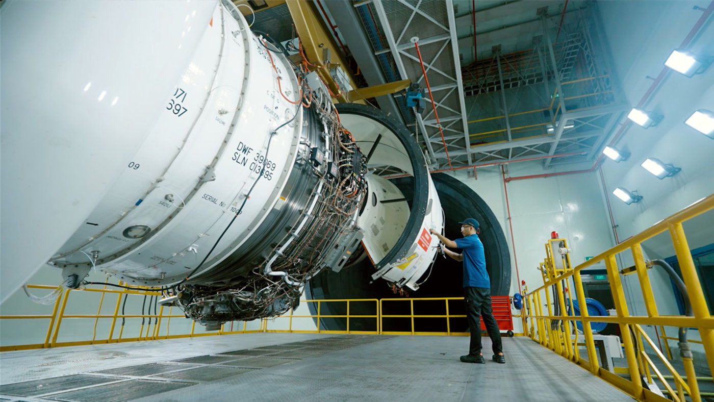 technician inspecting jet engine