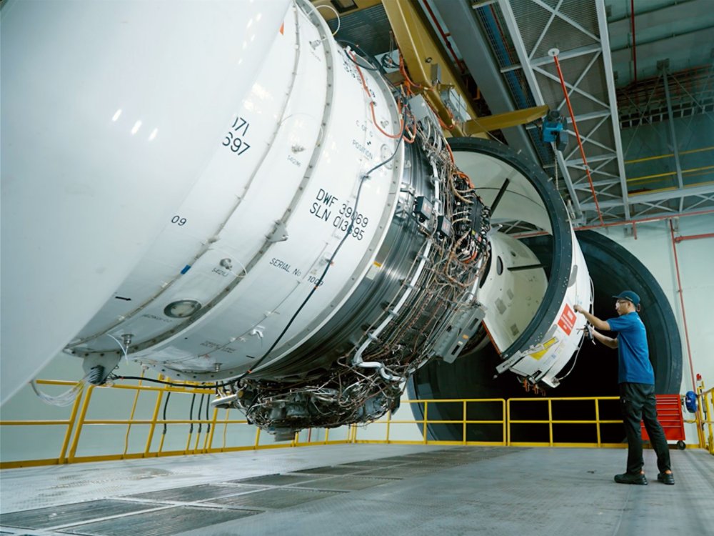 technician inspecting jet engine