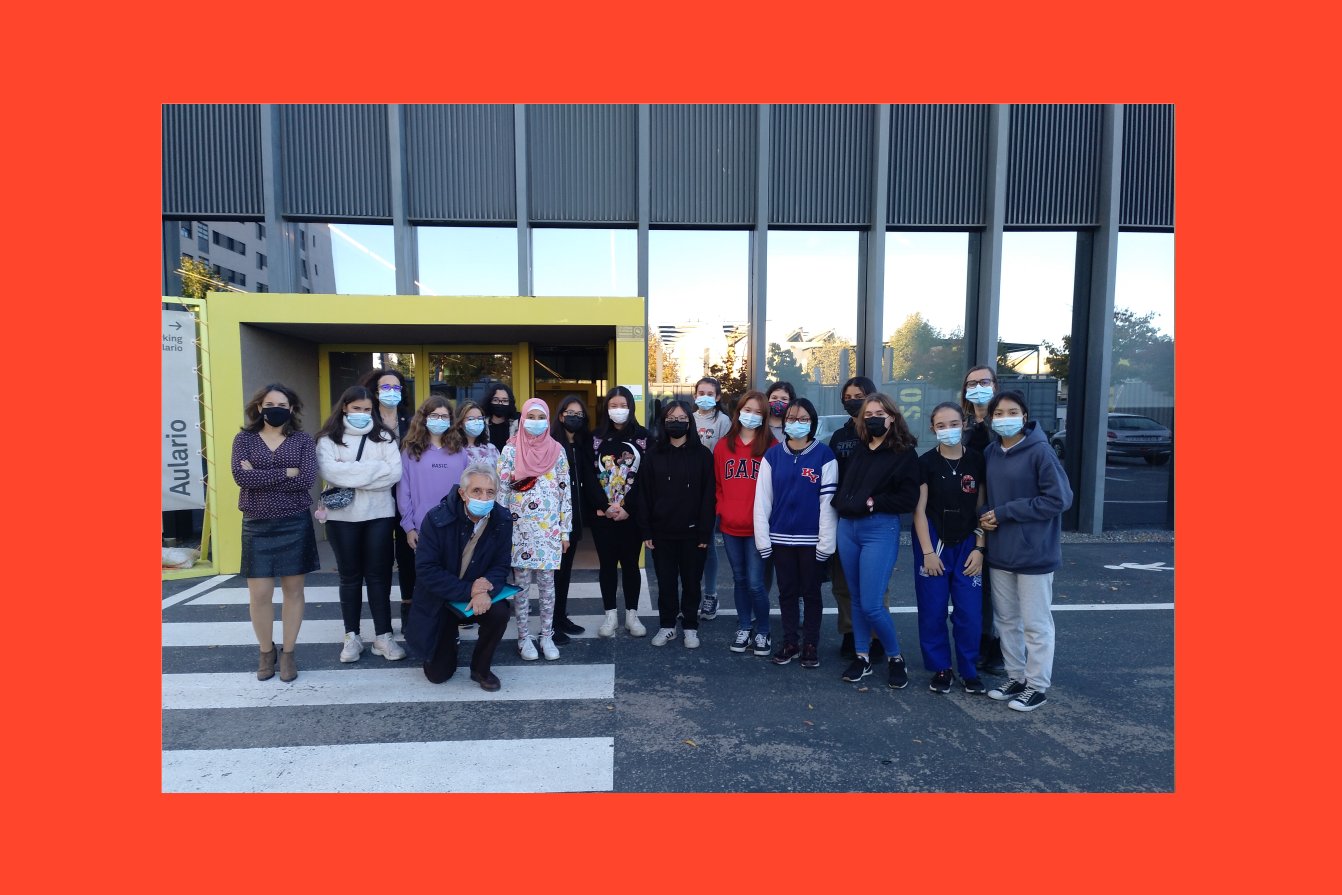 A group of people is standing in front of a building