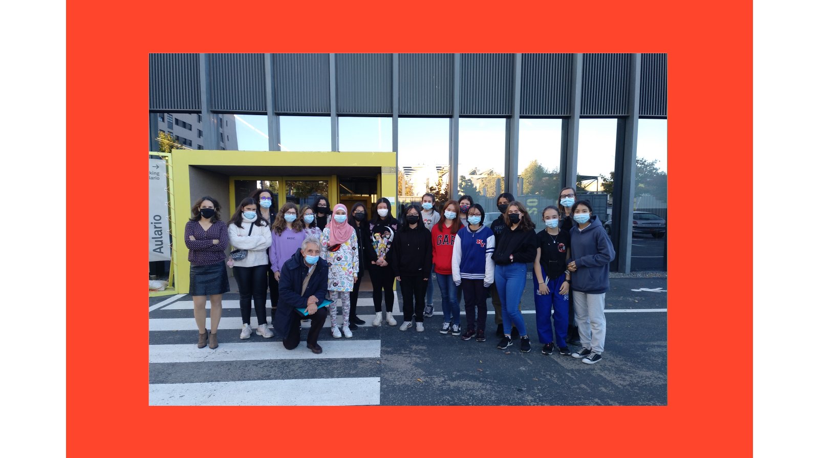 A group of people is standing in front of a building