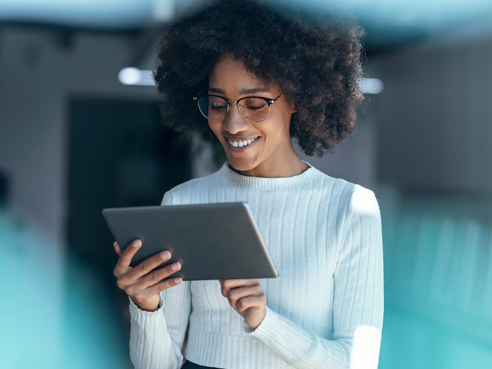 Smiling businesswoman using tablet PC at office