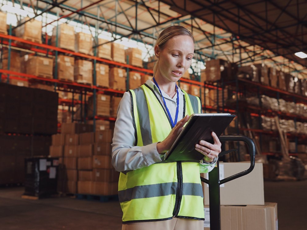 Logistics, woman and tablet in warehouse with inventory, stock and tech for delivery in supply chain or freight. Working, person and quality control in manufacturing, shipping in trade for export.