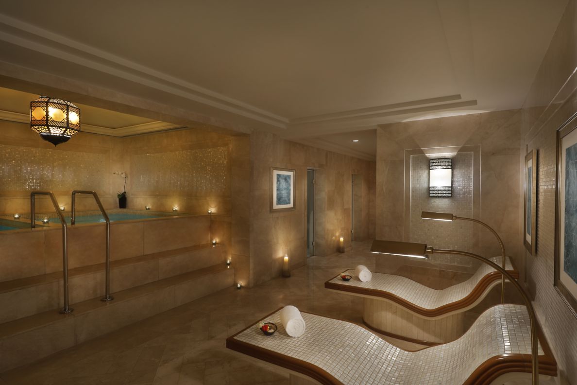 Steam room with plunge pool and tiled beds. 