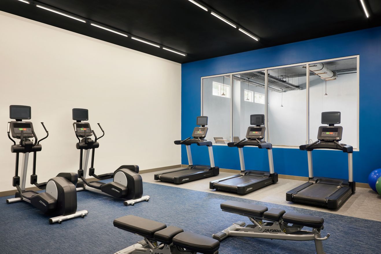 fitness room with treadmills and ellipticals