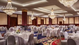Large event space with chandeliers and banquet tables