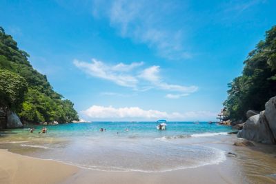 A beach surrounded with blue sky