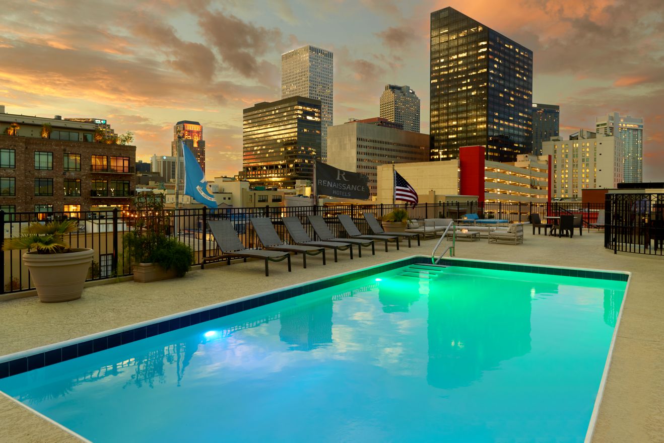 Rooftop pool and seating area with NOLA views