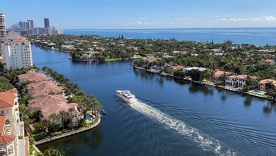 A boat traveling down a waterway during the day