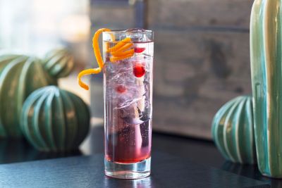 A colorful cocktail sits on a table