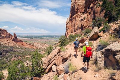 A group hikes through sandstone formations