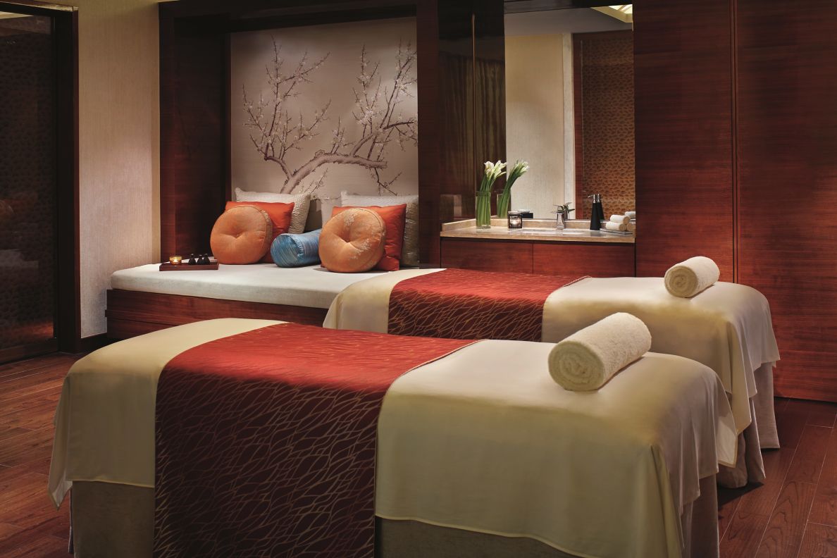 Two spa beds with a seating area in the back.
