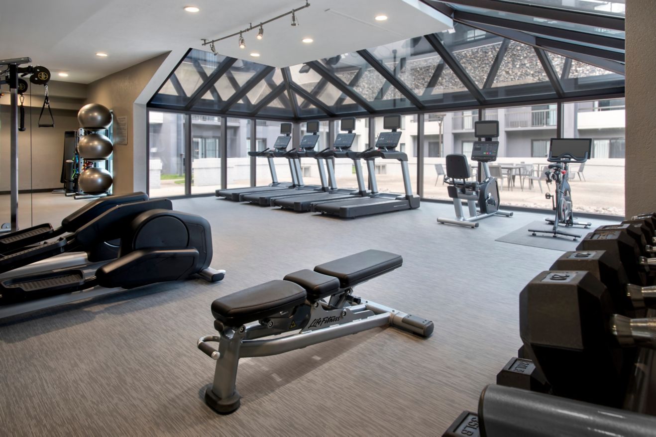 Spacious fitness center with courtyard view