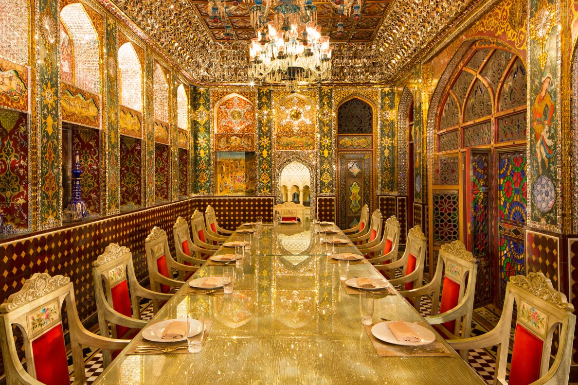 Long ornate table with gold and red decor. 