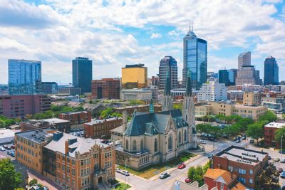 An aerial view of downtown Indianapolis featuring buildings and tree-lined streets