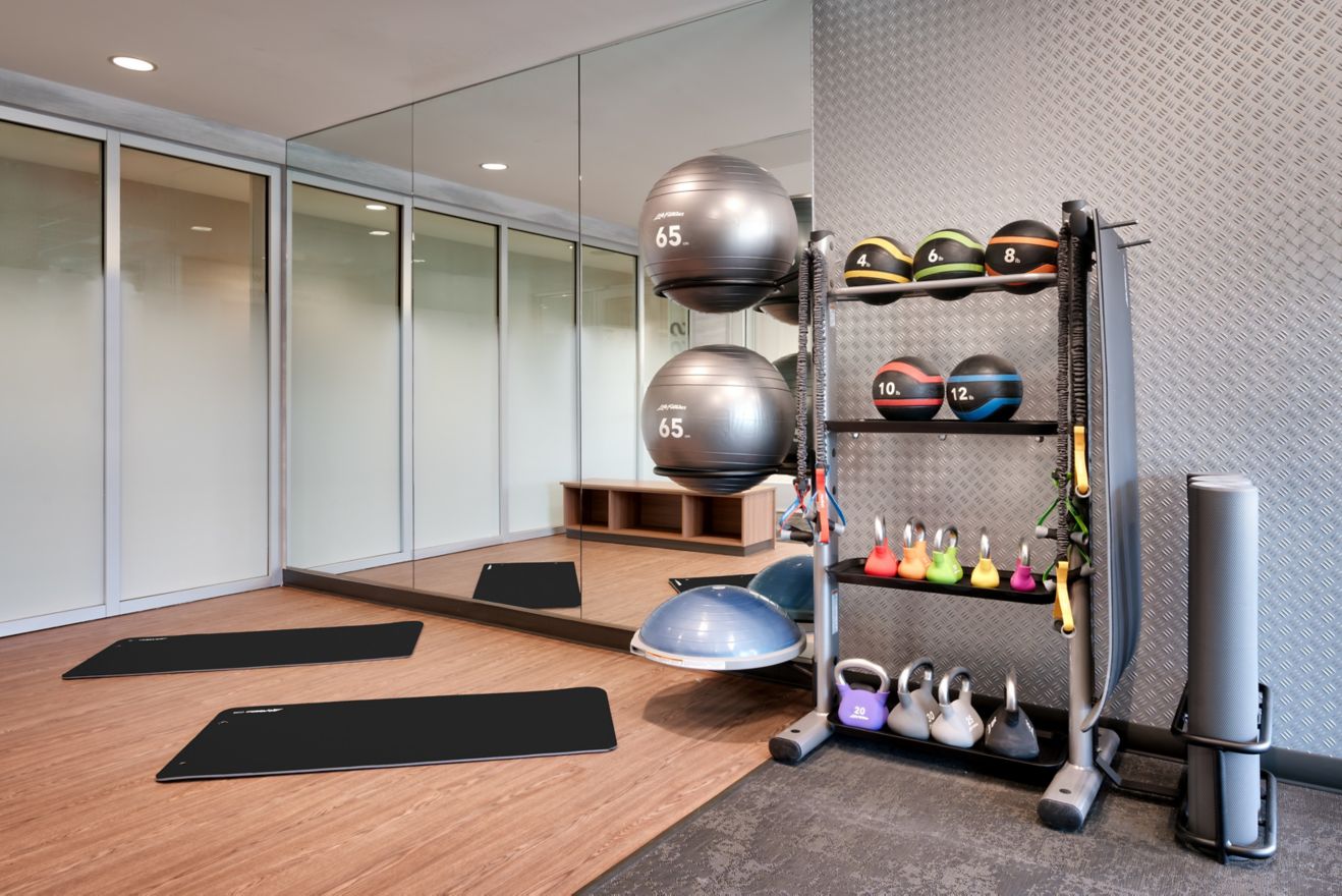 hotel fitness room with weights and mats