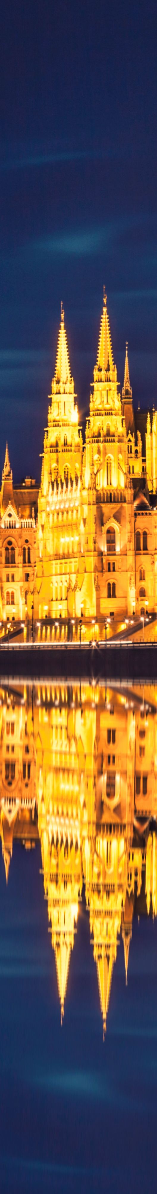 Evening view of a large domed building reflected in the water