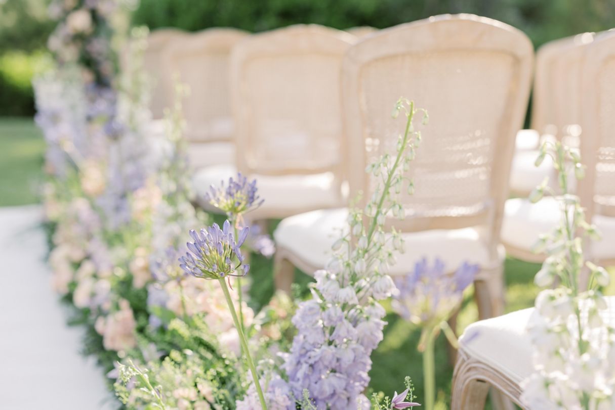 Outdoor wedding ceremony chairs and flowers