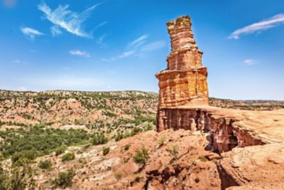 A sunny view of a rock formation in the desert