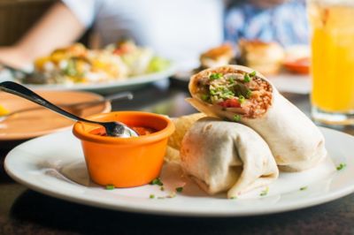 Burritos with salsa sauce on a dining table