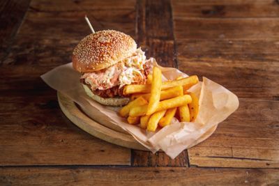 Pulled pork sandwich on a plate with fries