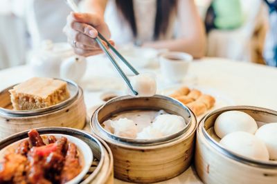 A table topped with dumplings and other lunch fare