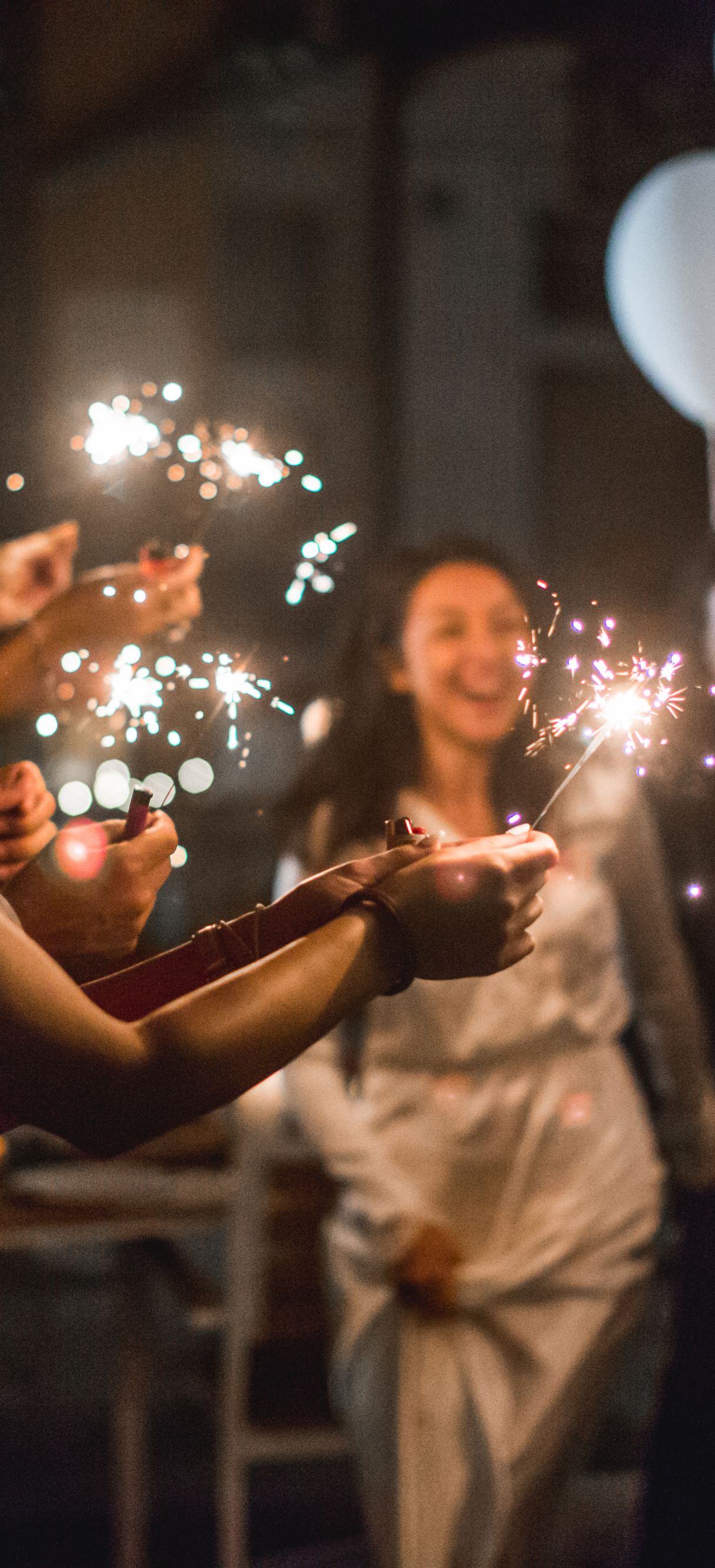 People celebrating newlyweds with sparklers