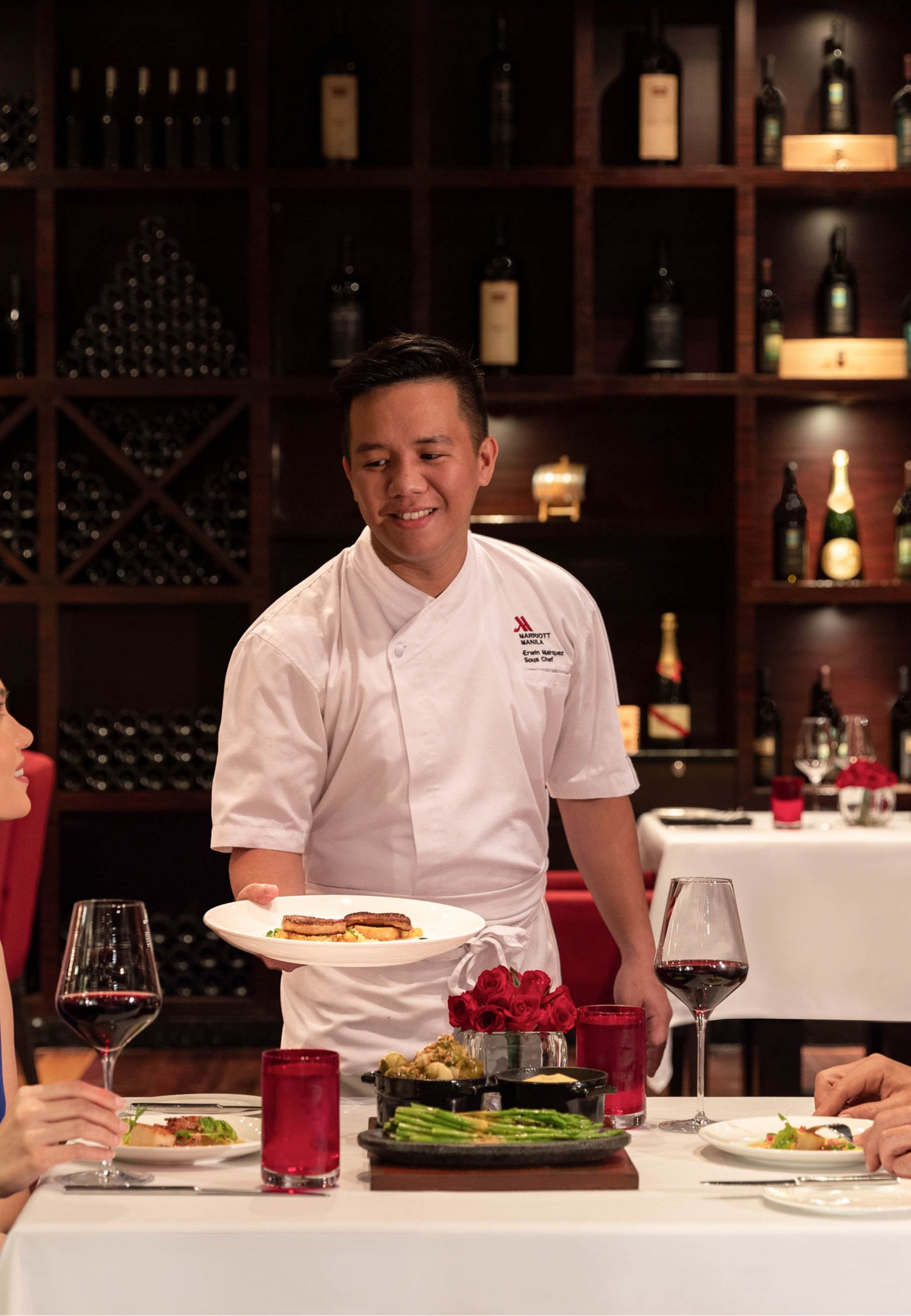 Chef presenting one of the dishes to the couple at