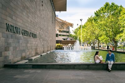 Couple sitting and relaxing by the fountain outsid