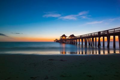 Pier in the ocean at sunset