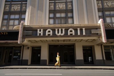 Woman walking in front of theater