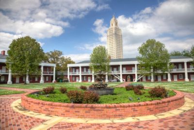 Historic building with tall building in back.