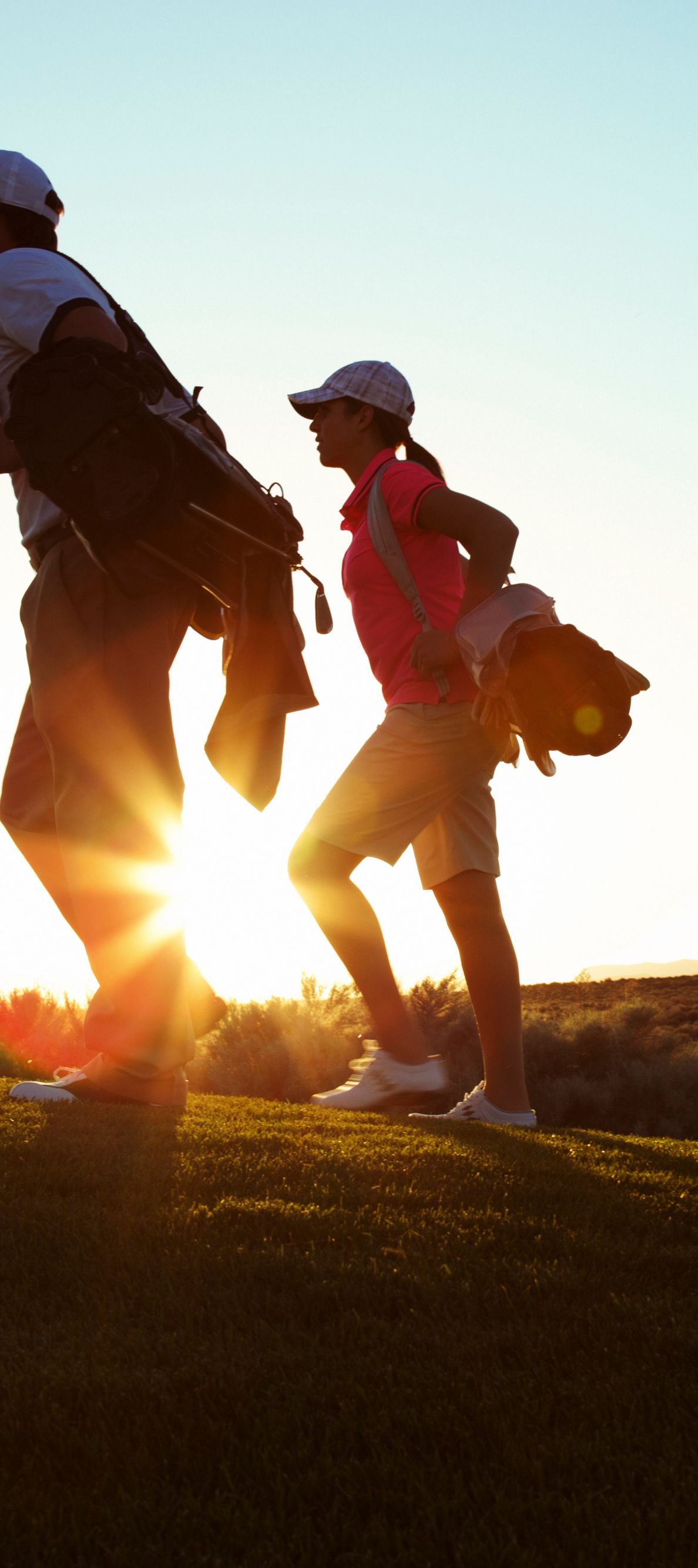 Two people playing golf.