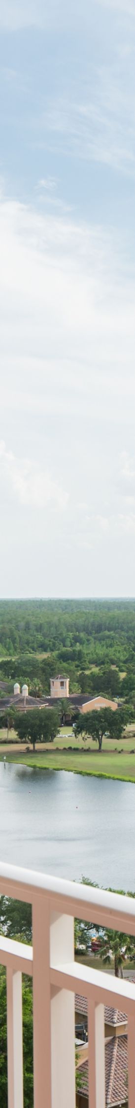 Couple enjoying the view from their hotel room balcony.