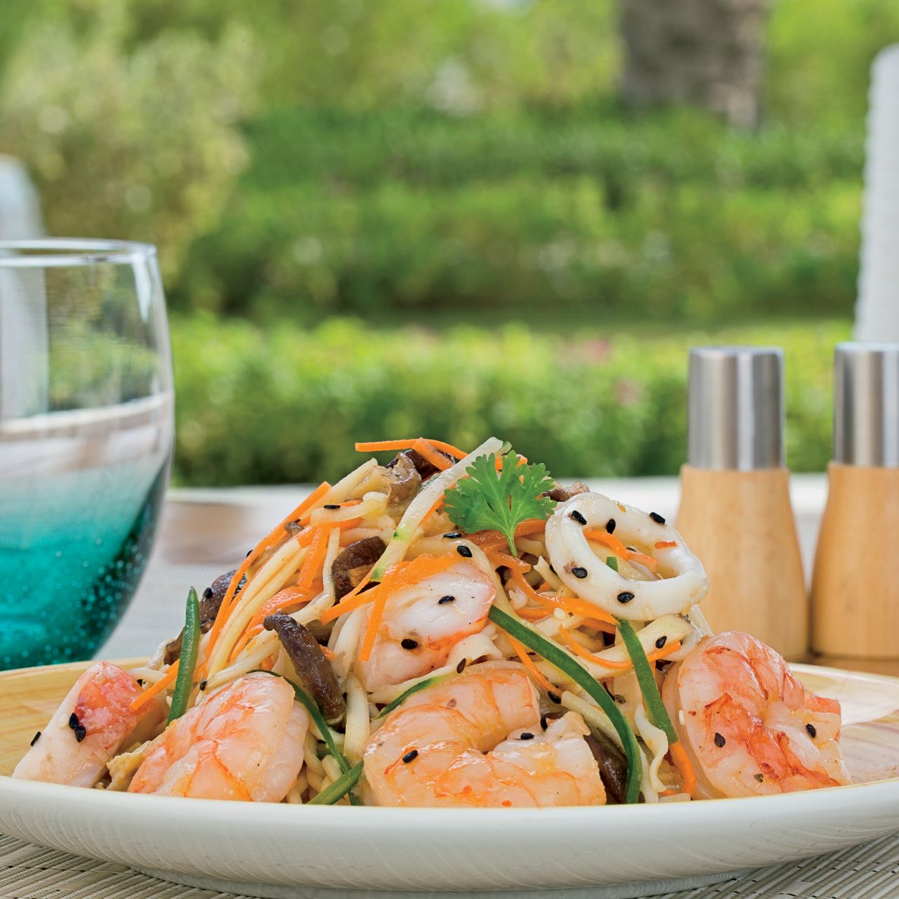 Fresh and colorful salad with shrimp set on an outdoor table
