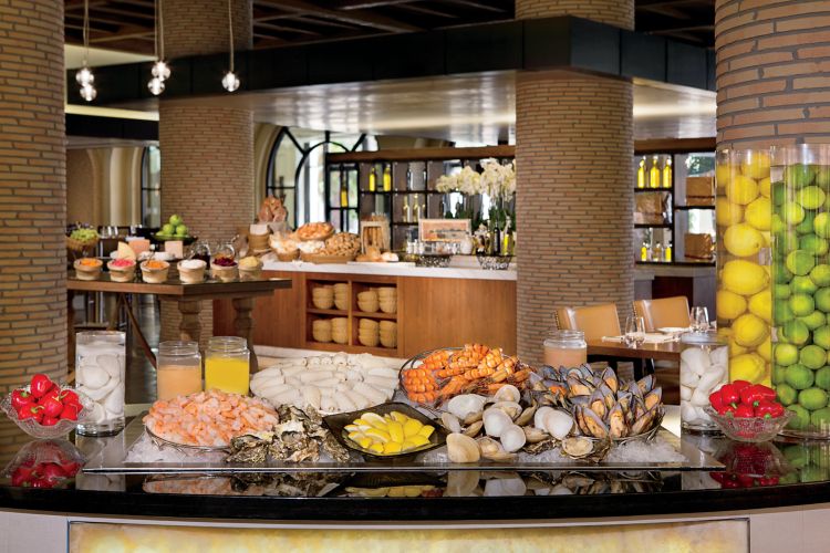 Buffet display of shrimp, seafood, citrus, drinks and more