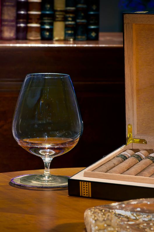 Cognac glass and box of cigars. 
