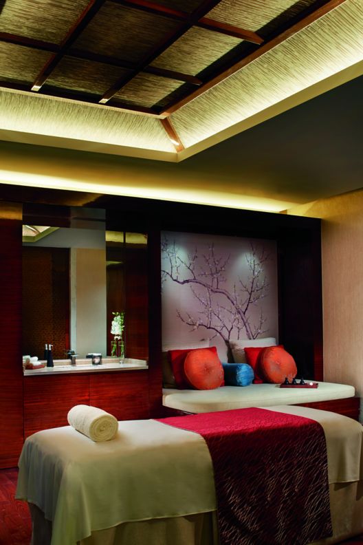 One spa bed with a seating area in the back.