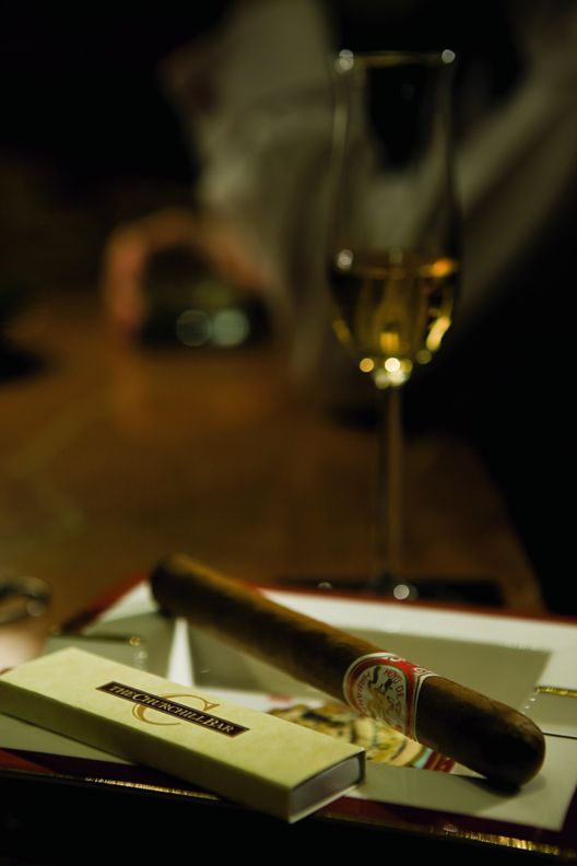 A cigar and a glass of alcohol.